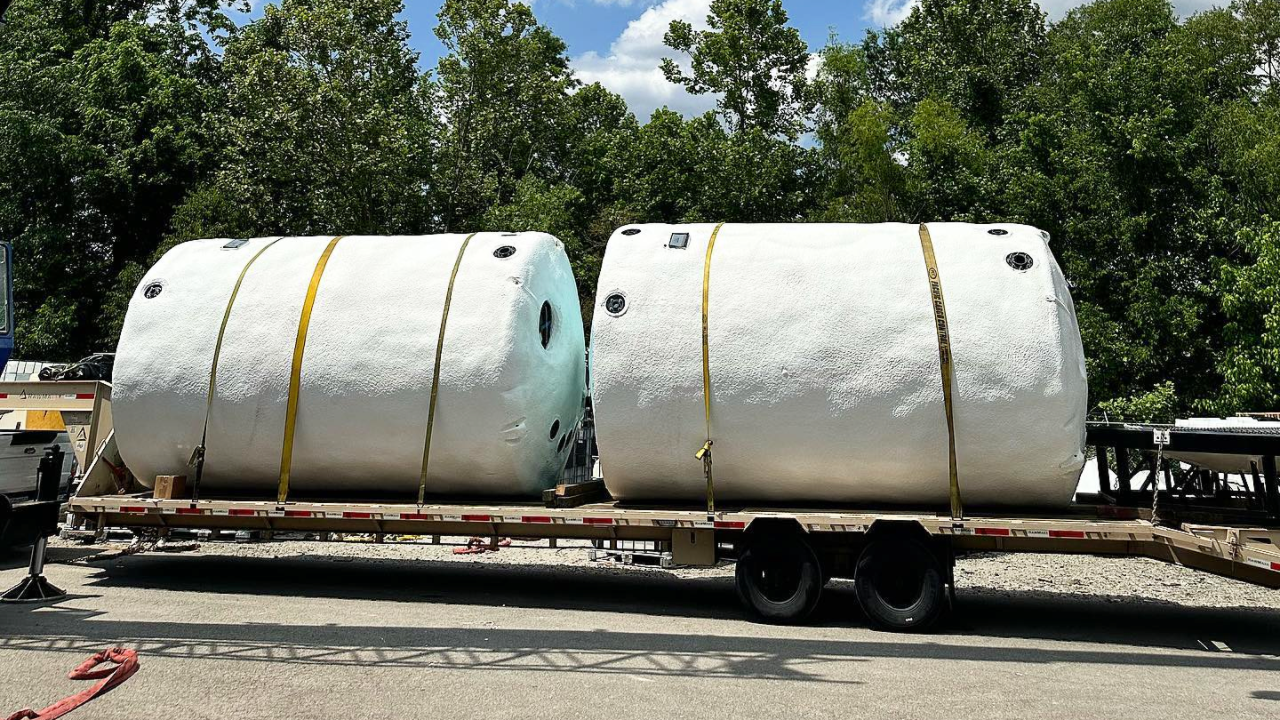 Insulated Polyethylene Storage Tanks Loaded on a Flatbed Transport Ready for Shipping and Use